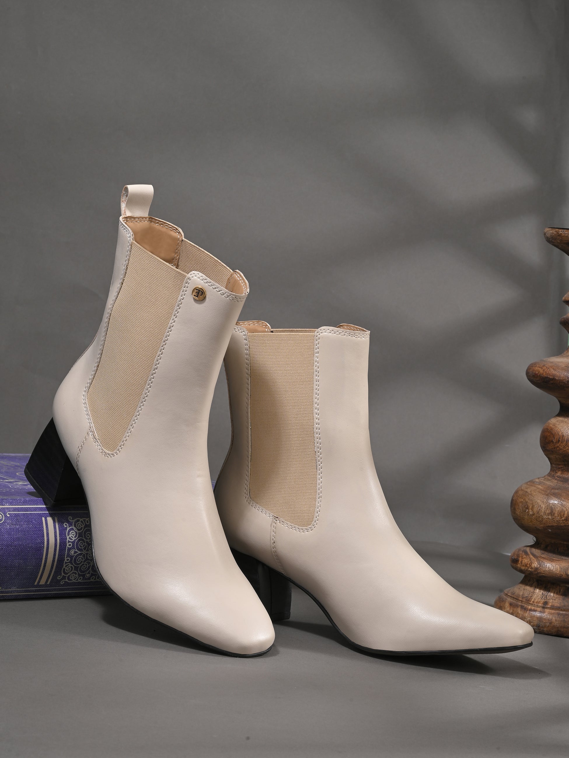 Women's black block heel ankle boots with smooth leather finish, elastic side panels, pull-tab, and pointed toe.