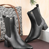Women's black block heel ankle boots with smooth leather finish, elastic side panels, pull-tab, and pointed toe.