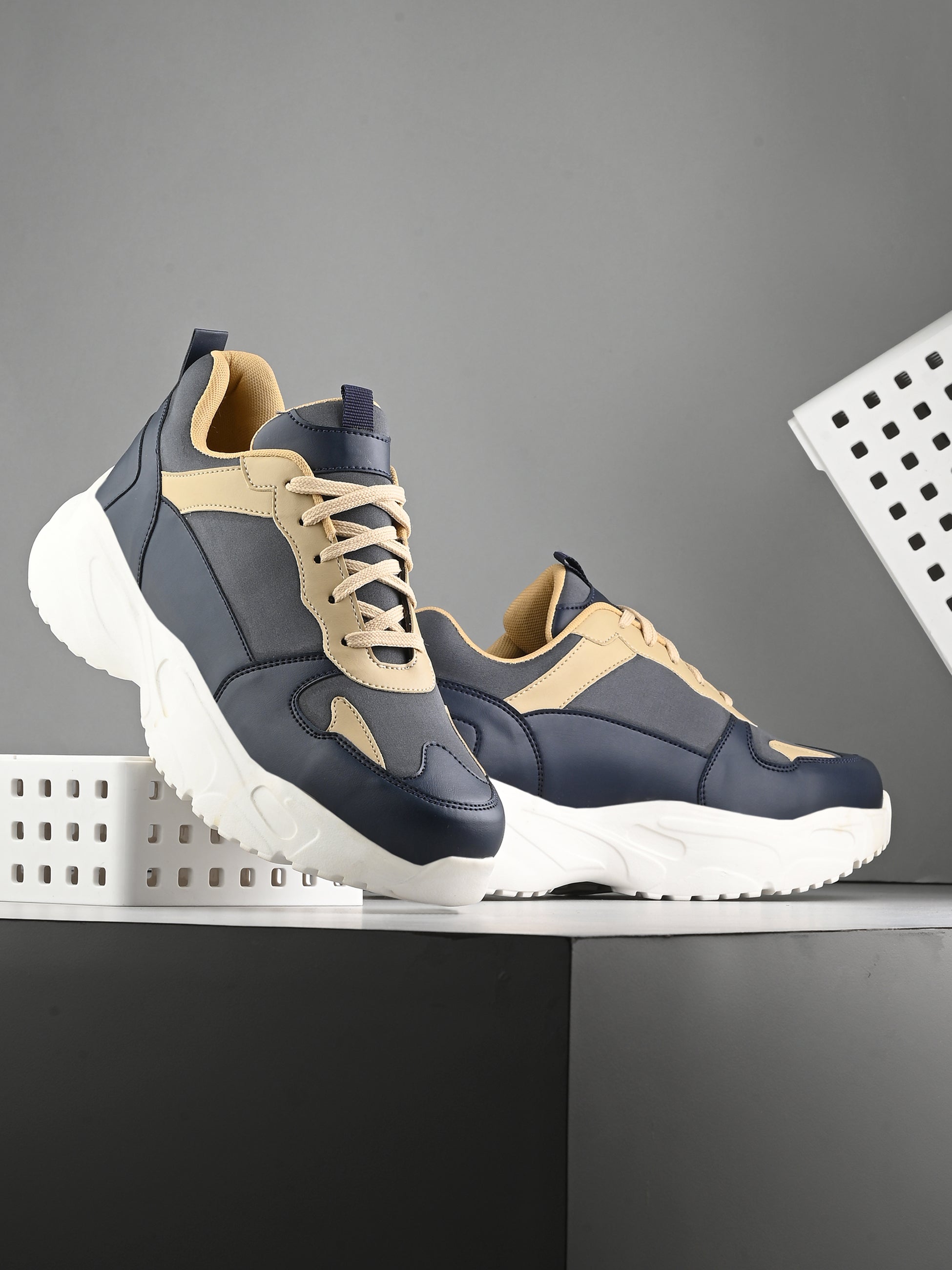 Navy blue and beige sneakers with a sleek design and durable chunky sole, perfect for a modern and stylish look. These are sleek design sneakers for men, combining comfort and fashion.