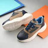 Navy blue and beige sporty sneakers for men with a chunky white sole, designed for a modern, athletic look with a bold, sporty aesthetic