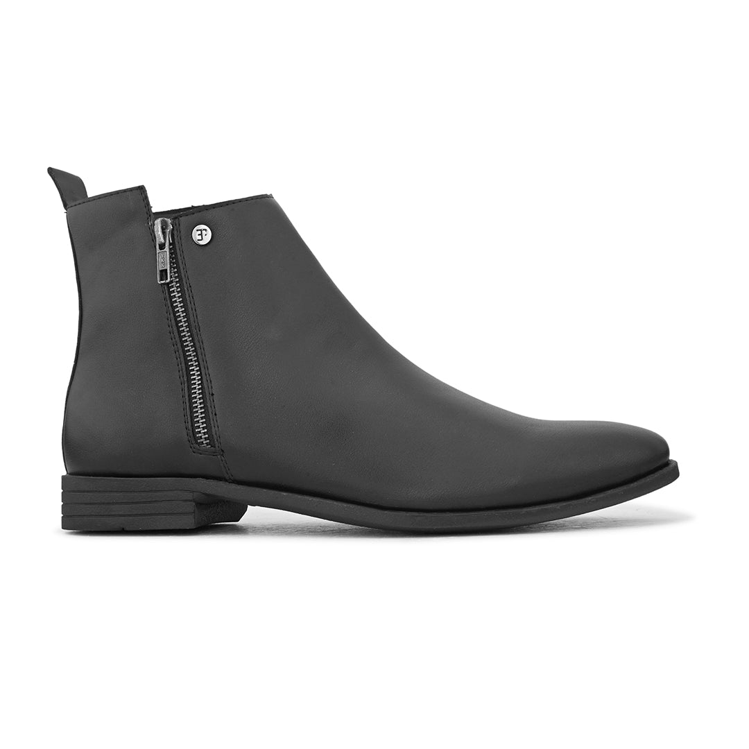 A sleek black leather Chelsea boot with a side zipper, pull-tab at the back, and a low block heel.