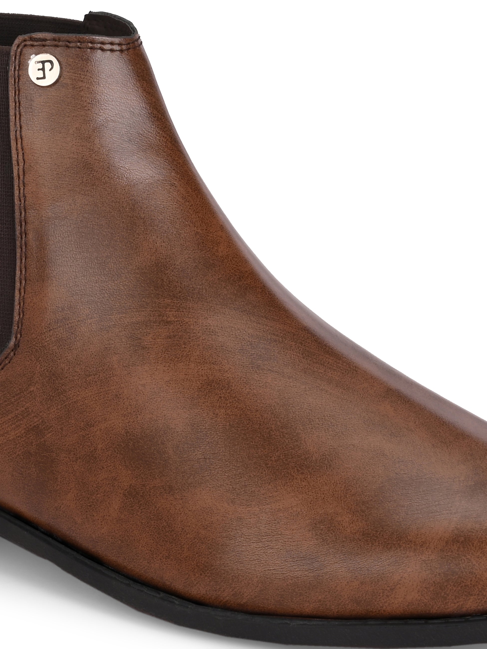 A sleek brown leather boot with elastic side panels, pull tab, low stacked heel, and a polished finish for a versatile look.