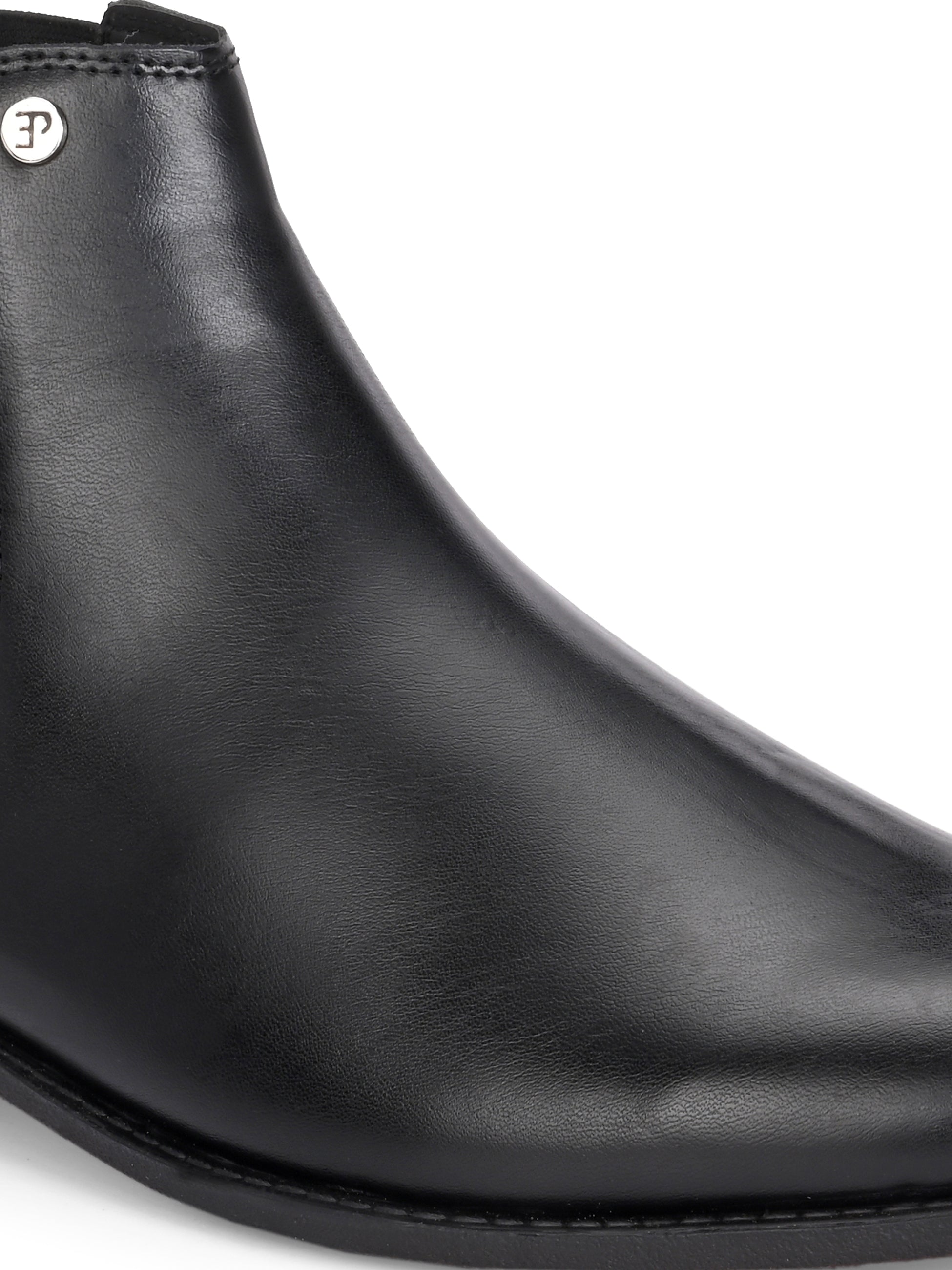 A sleek black leather boot with elastic side panels, pull tab, low stacked heel, and a polished finish for a versatile look.