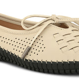 A beige women's flat with a perforated woven upper, round toe, metallic-tipped bow, and flexible black rubber outsole for comfort and casual wear.