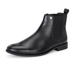 A sleek black leather boot with elastic side panels, pull tab, low stacked heel, and a polished finish for a versatile look.