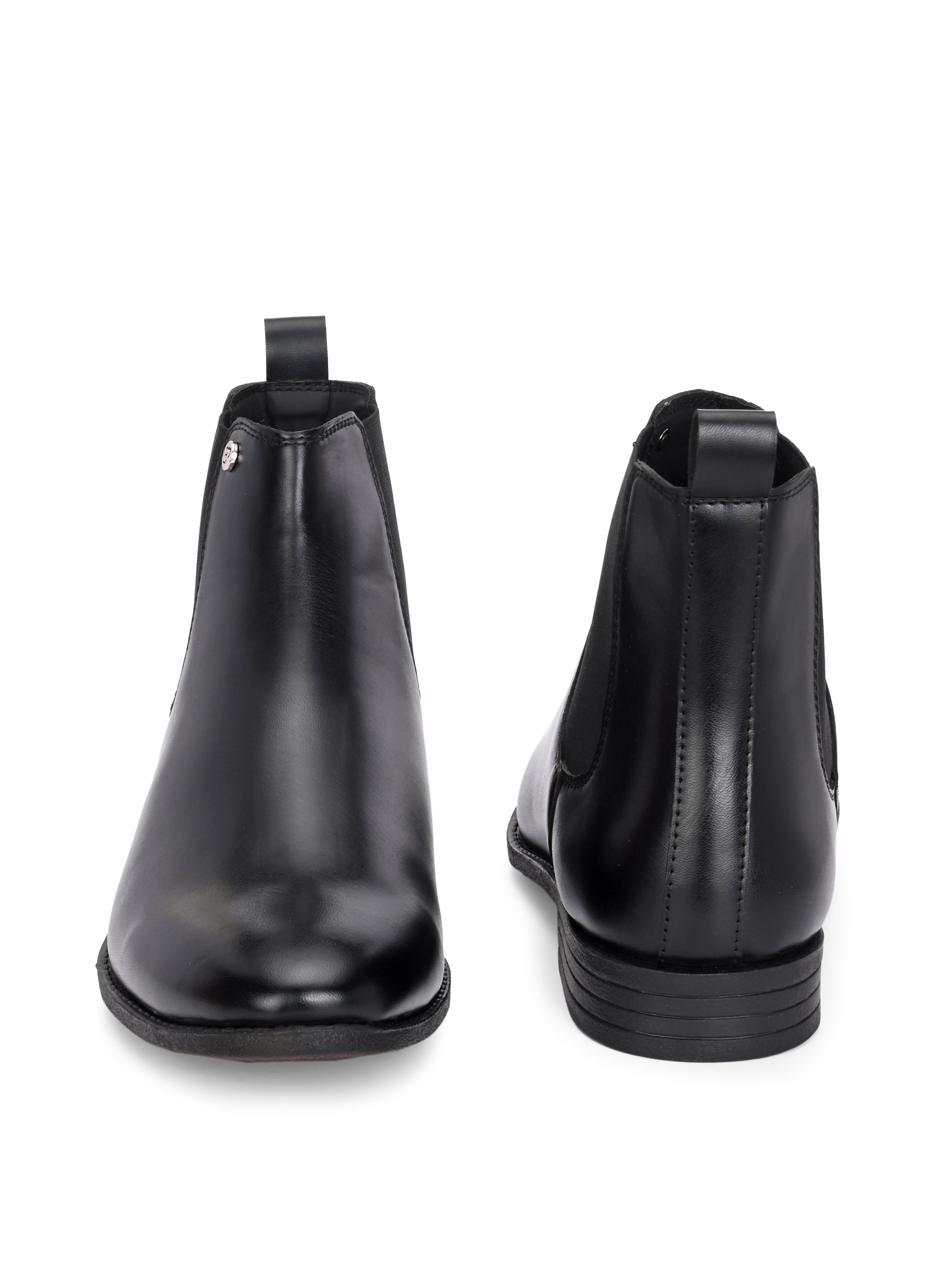 A sleek black leather Chelsea boot for women with elastic side panels, pull tab, low stacked heel, and a polished finish for a versatile look.