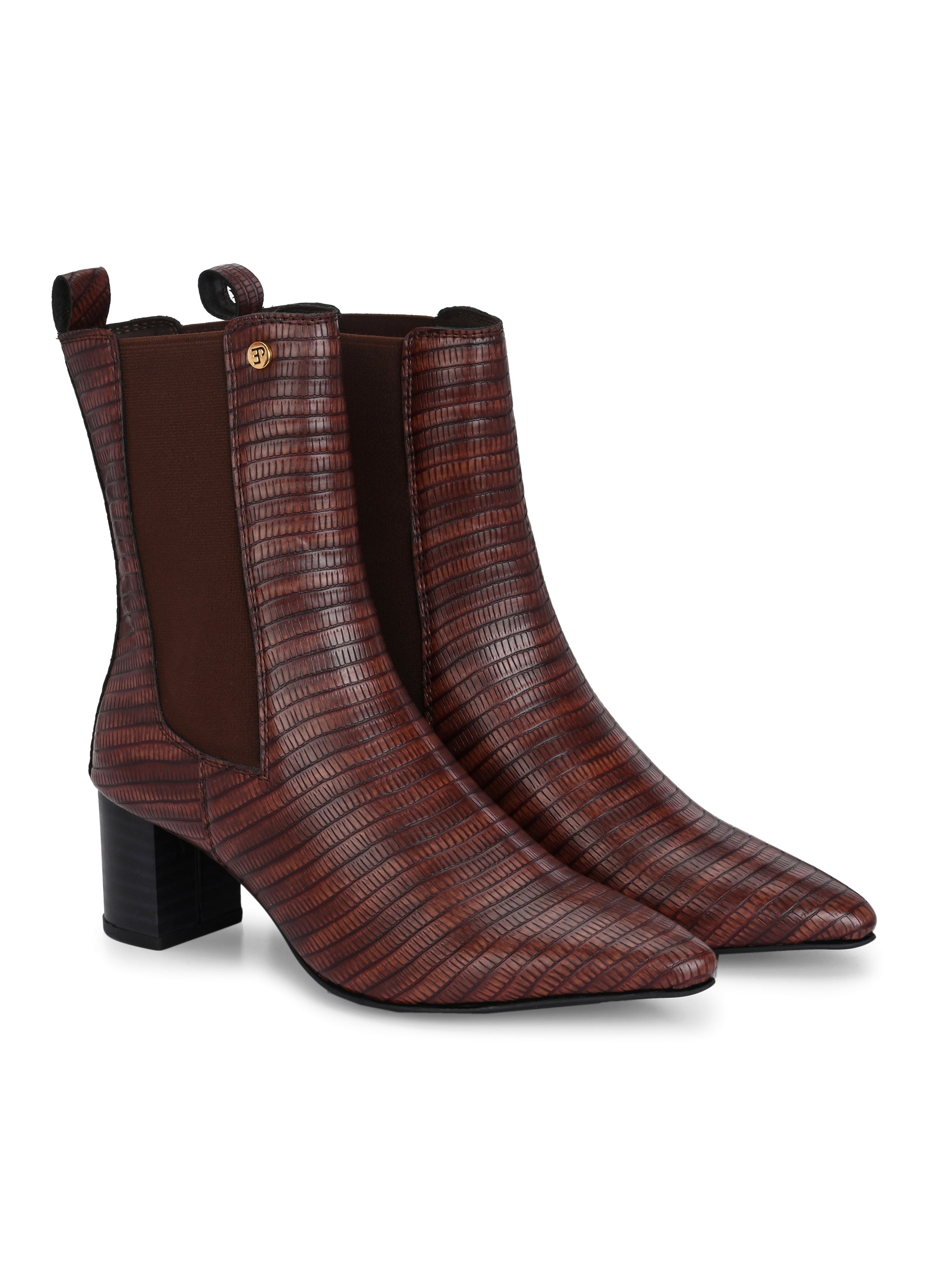 A sleek Tan crocodile-textured ankle boot with a pointed toe and mid-block heel, featuring an elastic side panel and a gold accent logo.