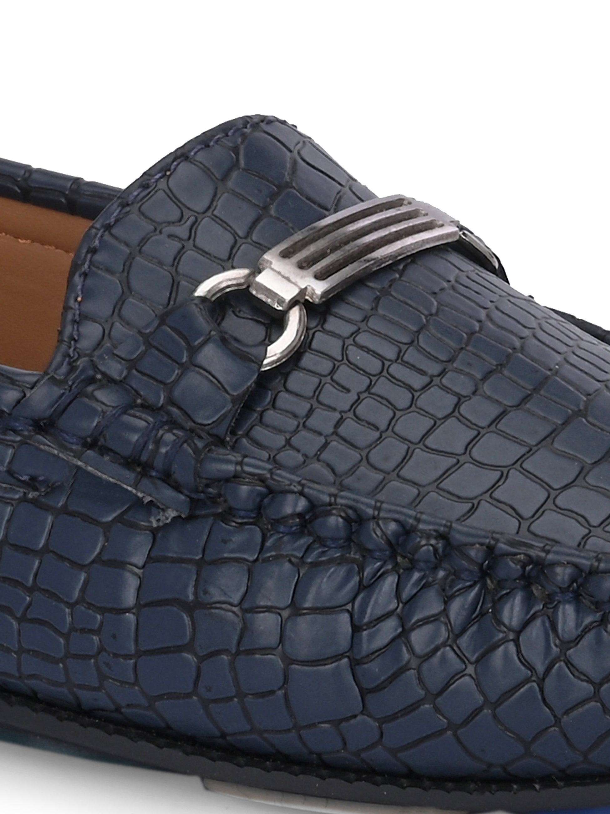 A stylish navy-blue loafer with a textured crocodile-pattern design, featuring a metallic buckle detail on the upper and colorful accents on the outsole.