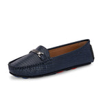 A stylish navy-blue loafer with a textured crocodile-pattern design, featuring a metallic buckle detail on the upper and colorful accents on the outsole.