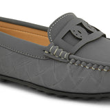 A gray loafer with textured stitching and a decorative strap across the top, viewed from the side.