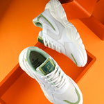 Women Sneakers in green with a sleek design and lightweight construction, perfect for athletic activities and all-day comfort.