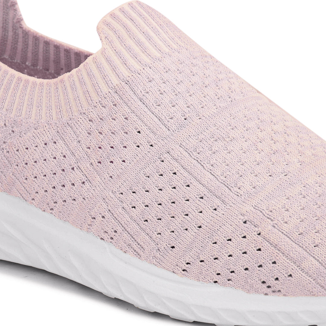 Light pink slip-on sneaker with a breathable knitted upper, perforated design for ventilation, and a cushioned white sole for comfort and flexibility.
