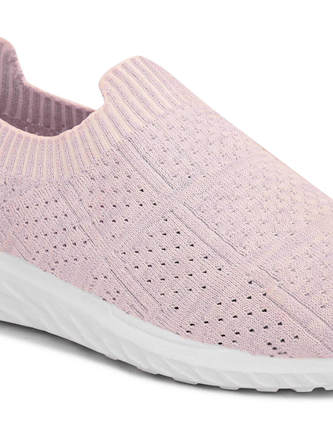 Light pink slip-on sneaker with a breathable knitted upper, perforated design for ventilation, and a cushioned white sole for comfort and flexibility.