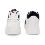White lace-up sneakers featuring a navy blue stripe detail on the sides, perforated detailing on the toe, and a lightweight rubber sole.