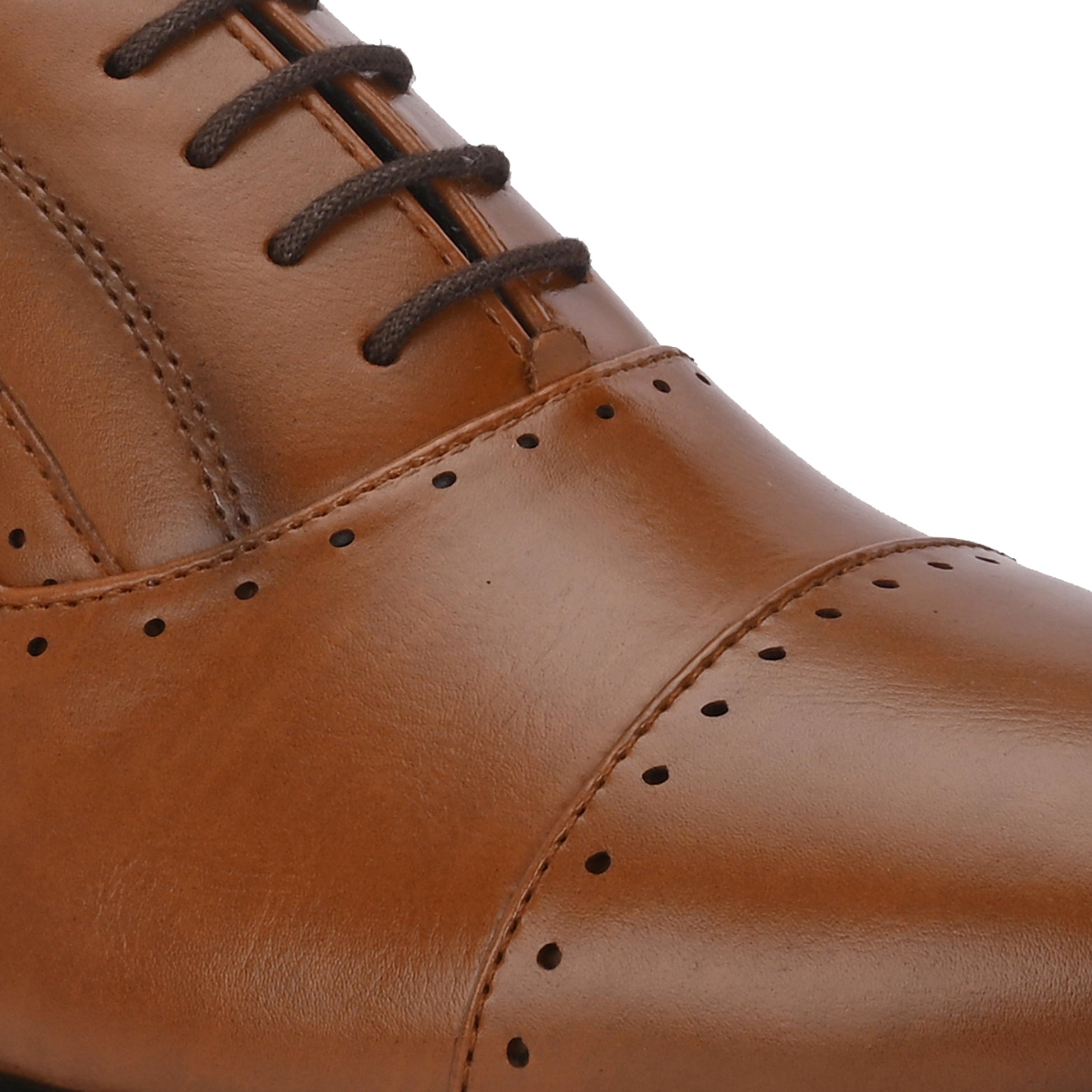  A brown leather dress shoe with a lace-up design, featuring decorative perforations along the toe cap and sides, and a low black heel.