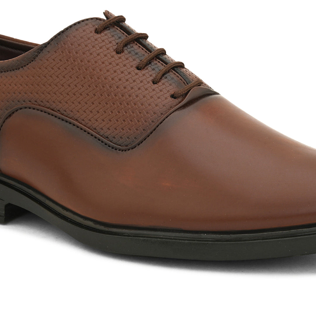 A brown leather dress shoe with laces on a white background.