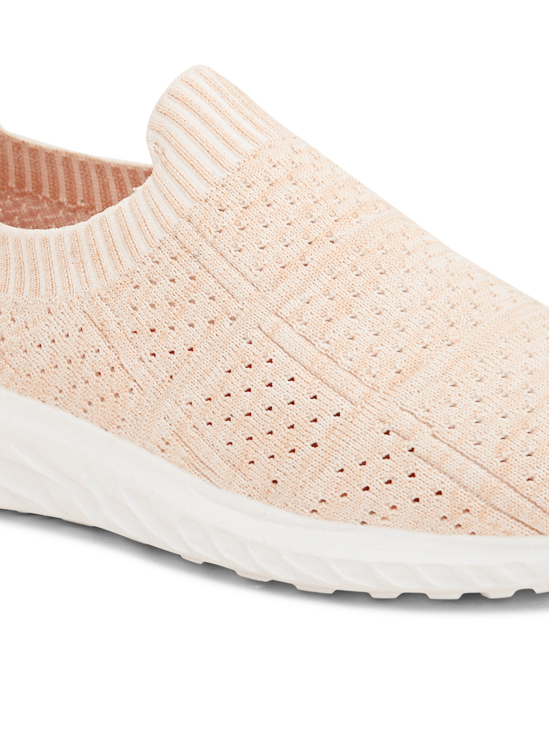 Peach slip-on sneaker with a breathable knitted upper, perforated design for ventilation, and a cushioned white sole for comfort and flexibility.