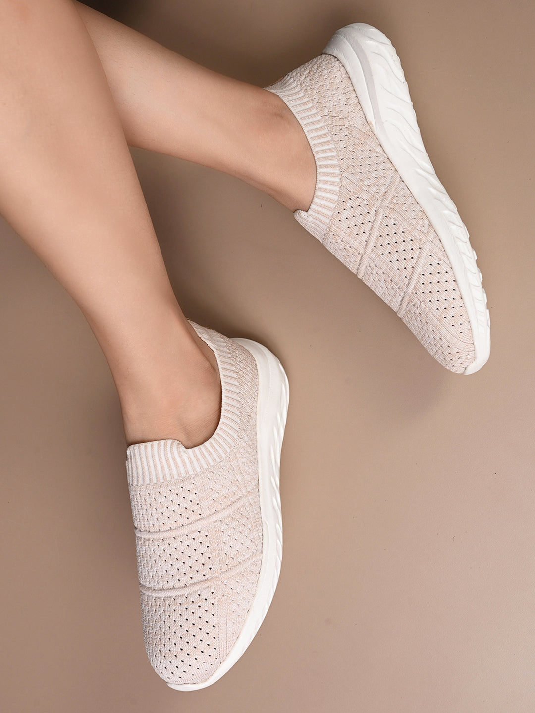 Peach Slip-On Lightweight Women Shoes with a breathable knitted upper, perforated design for ventilation, and a cushioned white sole for comfort and flexibility.