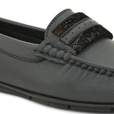 A single dark gray leather loafer with a textured sole and decorative strap across the front.
