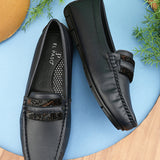 A single dark gray leather sleek loafer for women with a textured sole and decorative strap across the front.