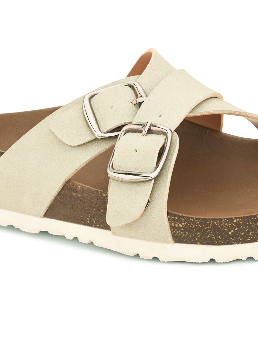 White slip-on flats, showcasing its design and material details.