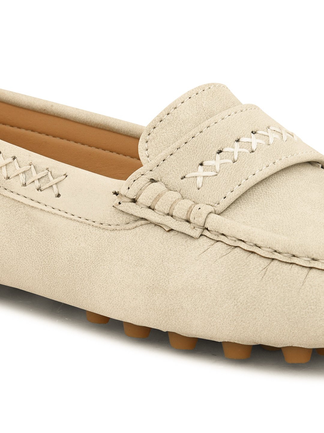 Beige suede driving loafer with stitched details, cross-stitched vamp band, and studded rubber sole.
