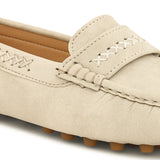Beige suede driving loafer with stitched details, cross-stitched vamp band, and studded rubber sole.