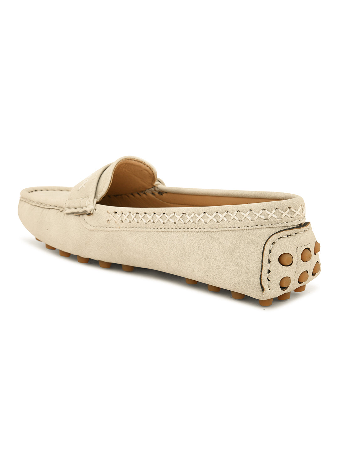 Beige suede driving loafer with stitched details, cross-stitched vamp band, and studded rubber sole.