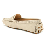 Beige suede driving loafer with stitched details, cross-stitched vamp band, and studded rubber sole.